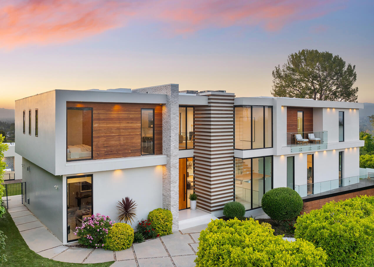 Large house at sunset being sold by high end realtor